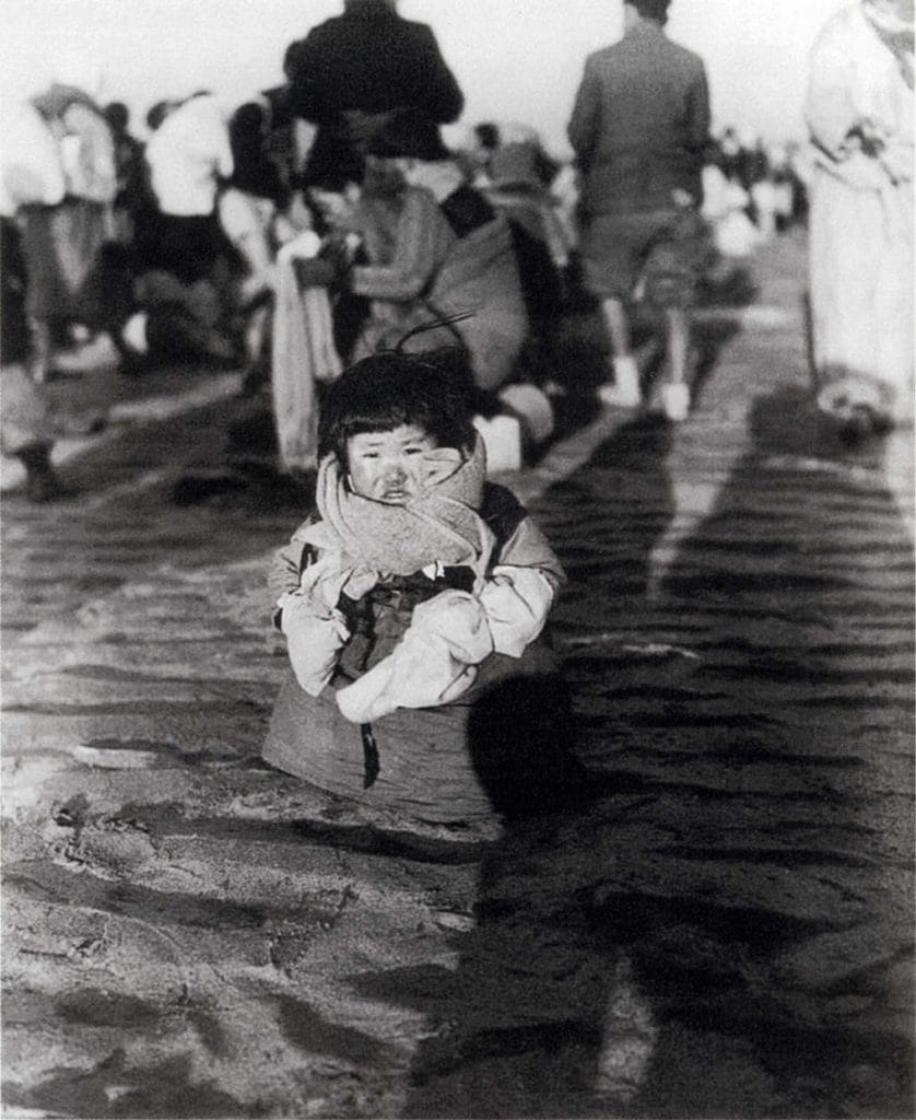 A woeful, uprooted child in frigid temperatures