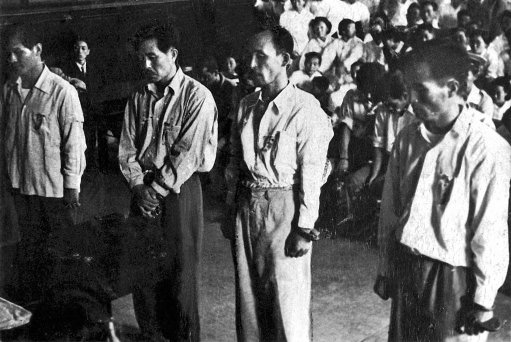 In court during their trial on July 29, 1955; despite the quality of the photo, Father is identified as the man at far right.