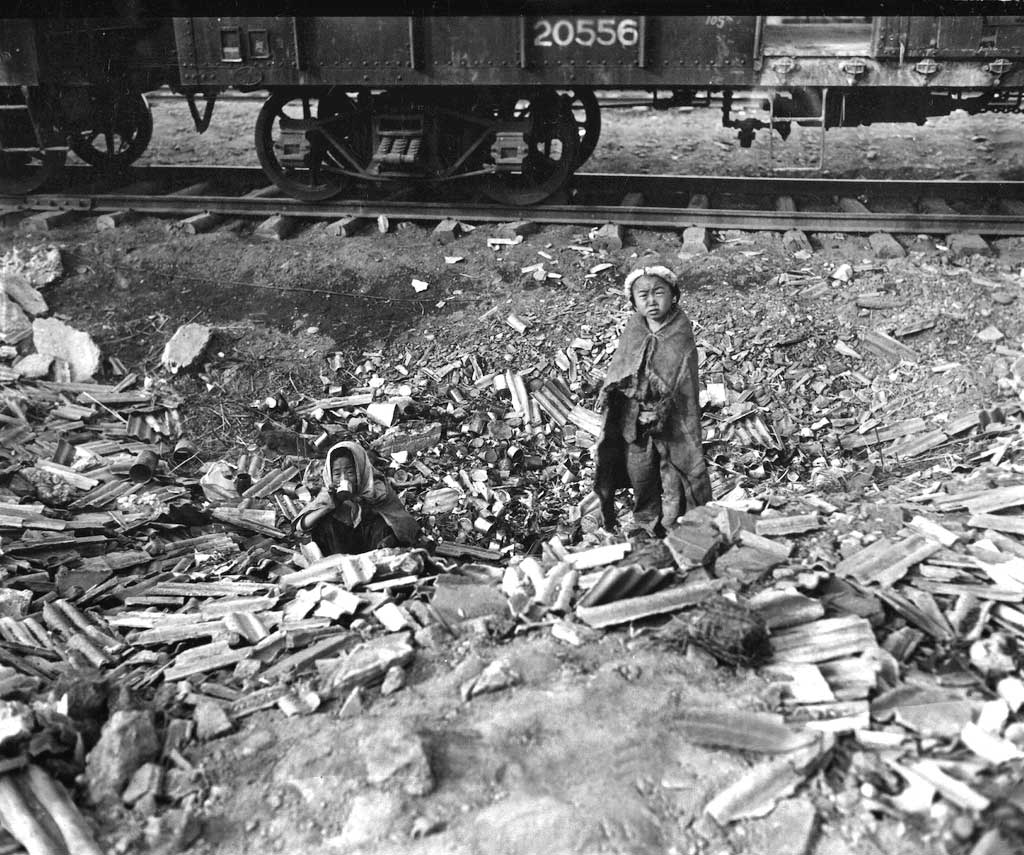 Scavenging for food, this brother and sister fight for survival in a railroad yard in Seoul in November 1950