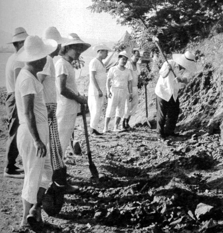 Father (at right, wielding a pickaxe) breaks the ground for the Cheongpyeong training center