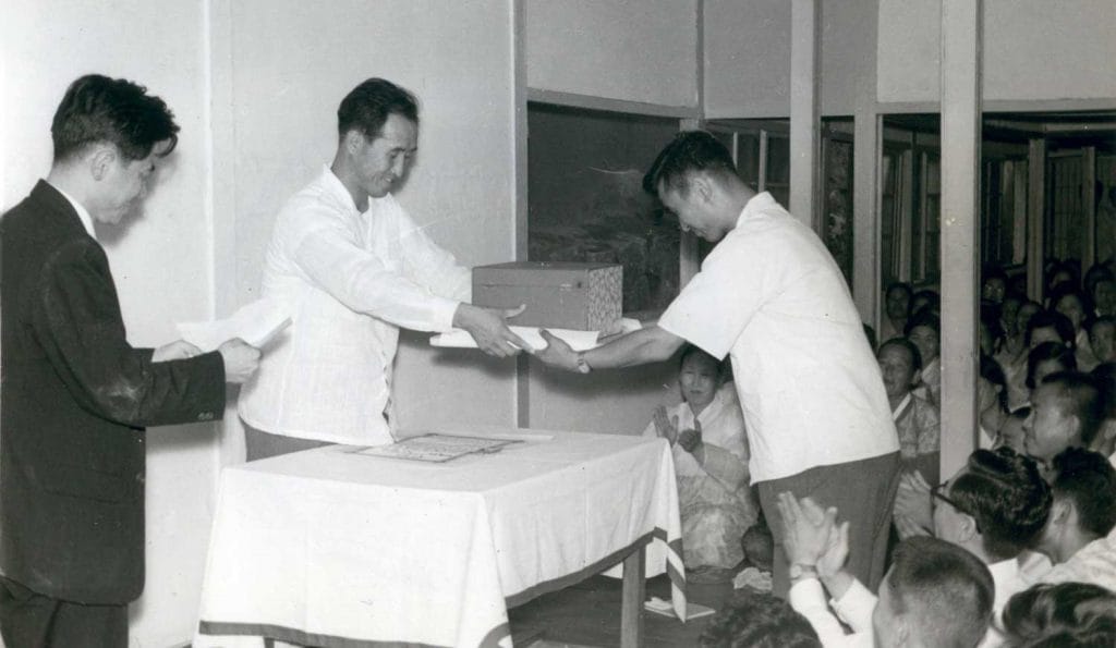 Father gives a prize to the winner of a lecture competition (1960)